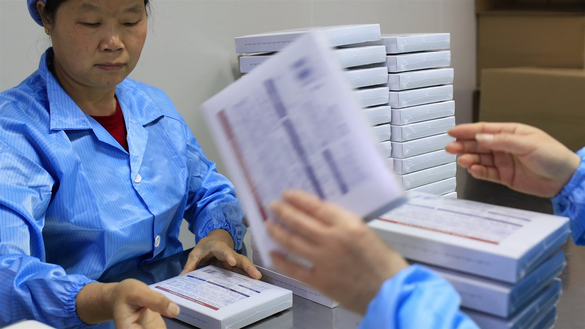 A worker packing skincare cartons on the production floor at the jogonglabs factory
