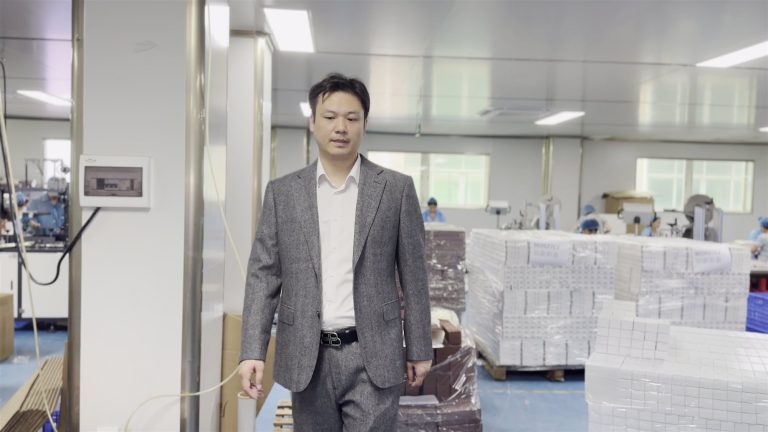 Tyler, founder of jogonglabs, walking through the warehouse and inspection area of the factory