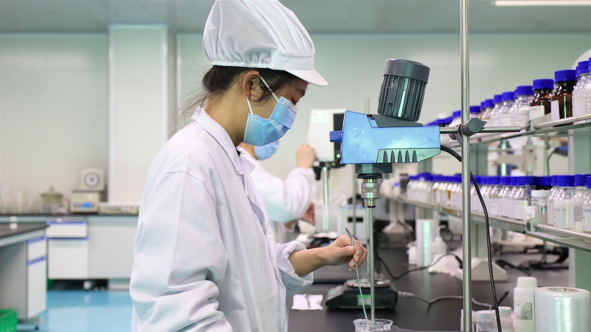 Two technicians working at a formulation bench in the jogonglabs laboratory