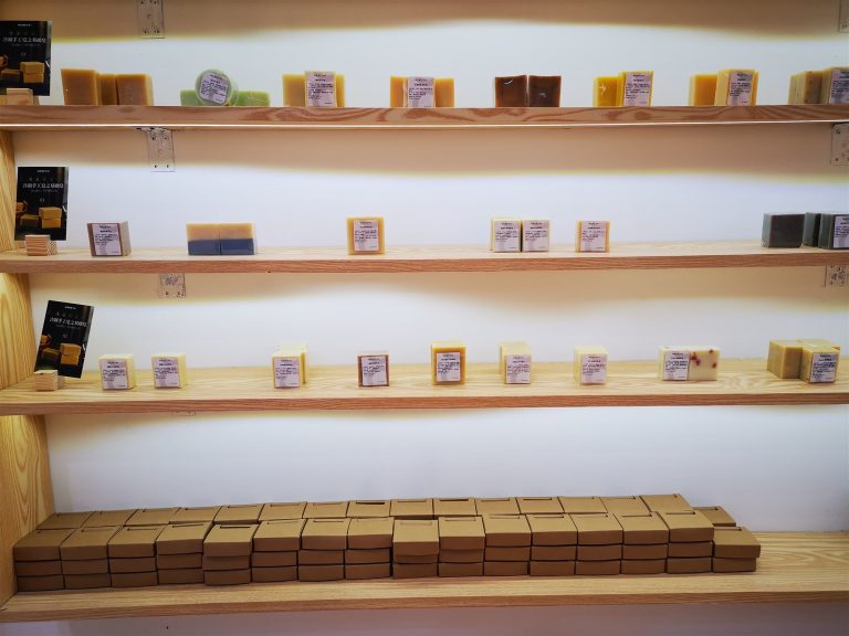 Rows of different skincare packaging samples on shelves at the jogonglabs factory